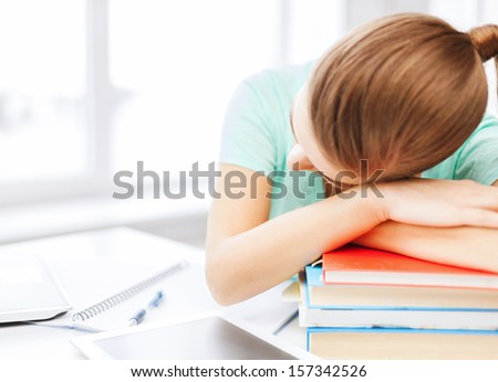 business, office, school and education concept - tired student sleeping on stock of books