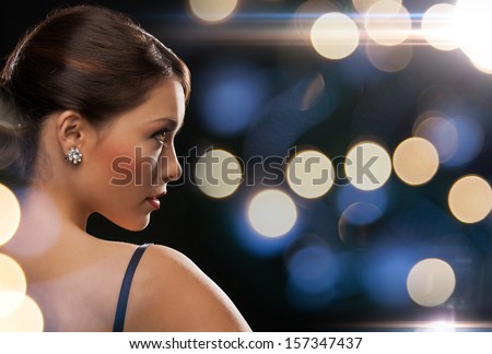 Luxury, Vip, Nightlife, Party Concept - Beautiful Woman In Evening Dress Wearing Diamond Earrings