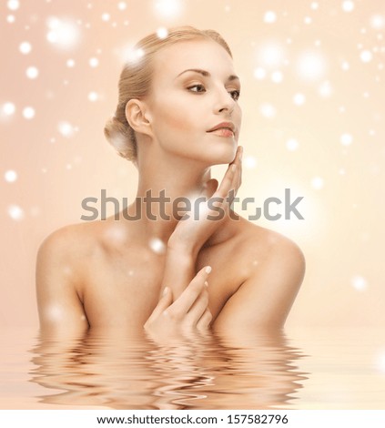 health, spa, beauty concept - face, hands and shoulders of beautiful woman