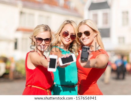 holidays and tourism modern technology concept beautiful blonde girls with smartphones in the city holidays and tourism modern technology concept beautiful blonde girls with smartphones in the city