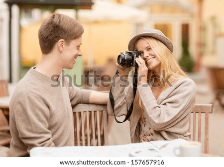 summer holidays and dating concept - couple taking photo picture at cafe in the city