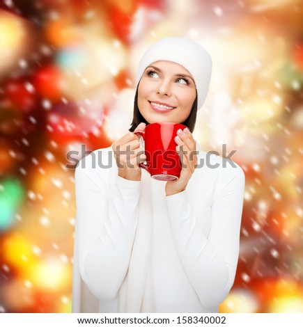 winter, people, happiness, drink and food concept - woman in hat with red tea or coffee mug