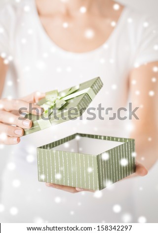 christmas, x-mas, gifts, presents, celebration concept - woman hands opening gift box