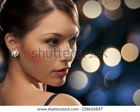 Luxury, Vip, Nightlife, Party Concept - Beautiful Woman In Evening Dress Wearing Diamond Earrings