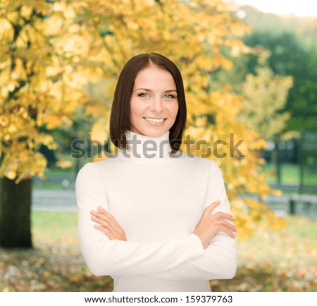 winter, people, happiness concept - smiling woman in white sweater