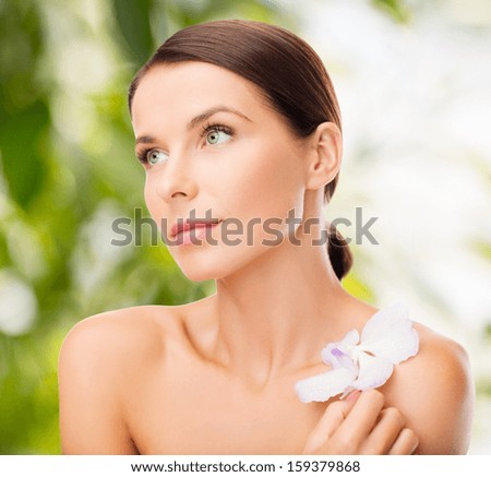 health and beauty, eco, bio, nature concept - relaxed woman with orhid flower