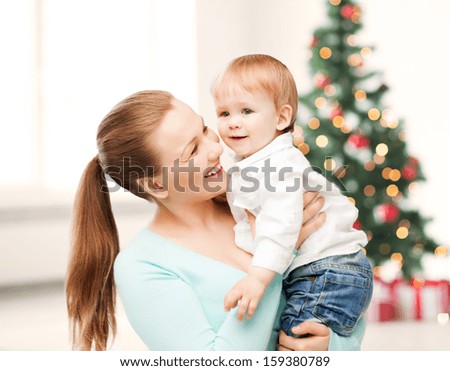 christmas, x-mas, winter, family, people, happiness concept - happy mother with adorable baby