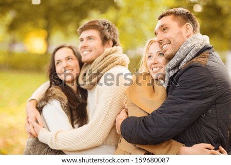 summer, holidays, vacation, happy people concept - group of friends or couples having fun in autumn park