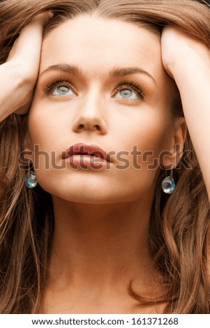 glamour, beauty and health, concept - beautiful calm woman with beautiful earrings holding head and looking up