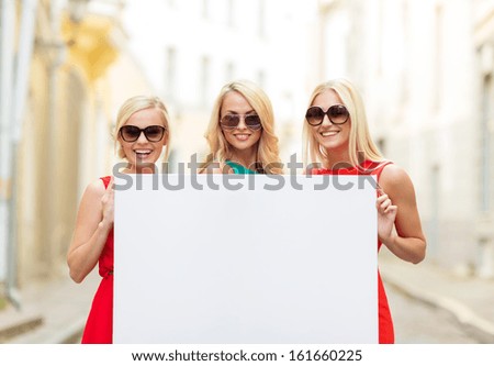 Summer Holidays, , Travel, Tourism And Advertisement Concept - Three Happy Blonde Women With Blank White Board In The City