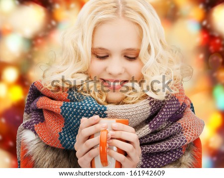 Winter, People, Happiness, Drink And Food Concept - Smiling Teenage Girl In Warm Clothes With Tea Or Coffee Mug