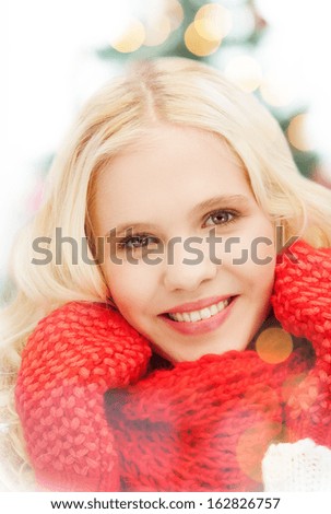 winter, christmas, xmas, x-mas, people, happiness concept - smiling teenage girl in red mittens and scarf