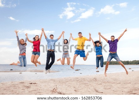 Summer, Holidays, Vacation, Happy People Concept - Group Of Friends Jumping On The Beach