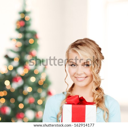 celebration, holidays, xmas concept - happy woman with gift box
