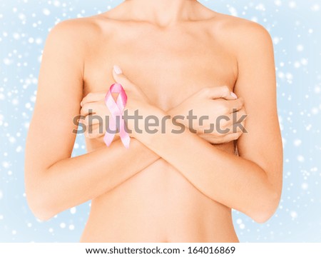 health, medicine, beauty concept - naked woman with breast cancer awareness ribbon