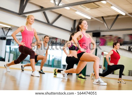 Fitness, Sport, Training, Gym And Lifestyle Concept - Group Of Smiling People Exercising In The Gym