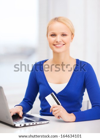 online shopping and technology concept - smiling young woman with laptop computer and credit card