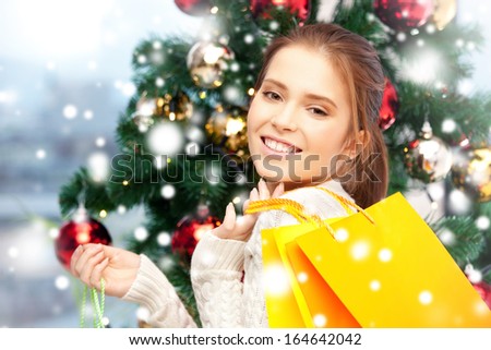 xmas, christmas, winter, holidays, shopping and happiness concept - happy woman with shopping bags and christmas tree