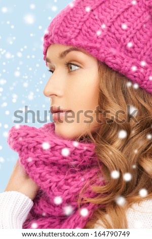 winter, people and happiness concept - beautiful woman in pink winter hat and muffler
