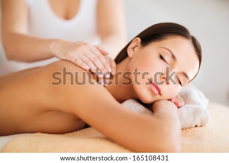 Beauty, Spa, Resort And Relaxation Concept - Beautiful Woman In Spa Salon Getting Massage