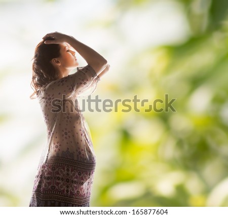 family, motherhood and pregnancy concept - silhouette backlight picture of pregnant beautiful woman