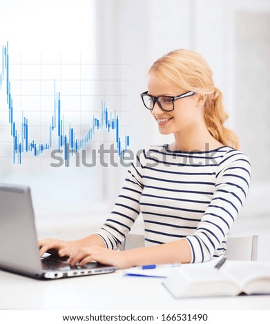 business, education, money and new technology concept - smiling student with laptop, book, computer, notebook, eyeglasses and forex chart