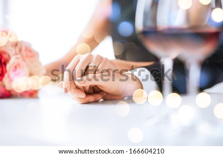 Love, Family, Anniversary Concept - Engaged Couple With Wine Glasses In Restaurant