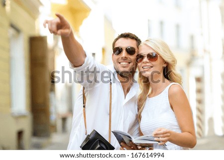 Summer Holidays, Dating, City Break And Tourism Concept - Couple With Camera And Travellers Guide