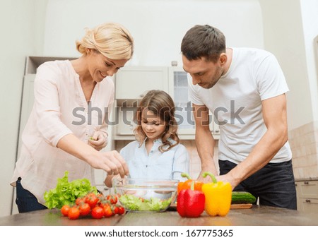 Food, Family, Hapiness And People Concept - Happy Family Making Dinner In Kitchen