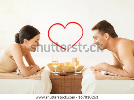 spa beauty love and happiness concept smiling couple with candles in spa salon drinking champagne spa beauty love and happiness concept smiling couple with candles in spa salon drinking champagne
