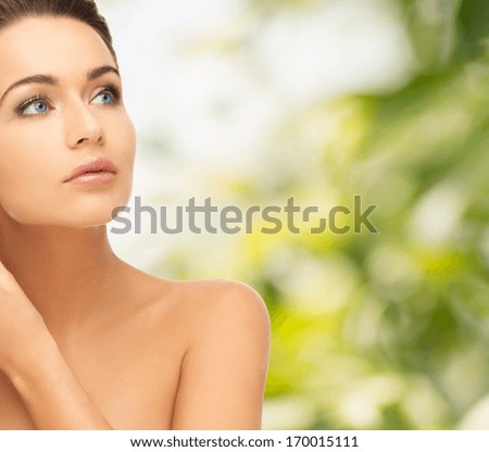 beauty and health concept - beautiful woman looking up