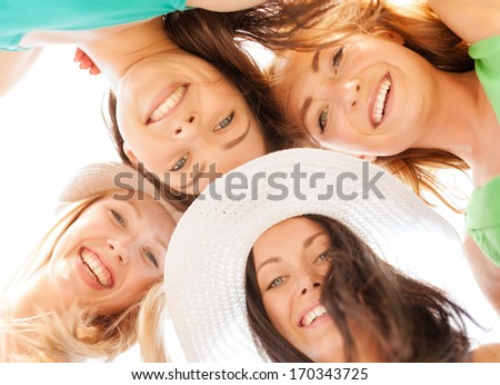 summer holidays and vacation concept - faces of girls looking down and smiling