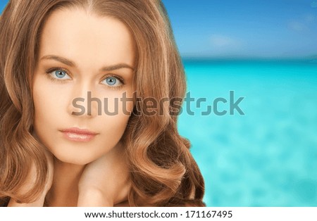 health and beauty concept - face and hands of beautiful woman with long hair