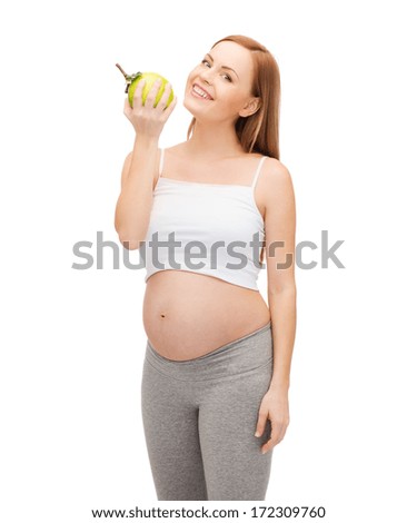pregnancy, motherhood and happiness concept - happy future mother with green apple