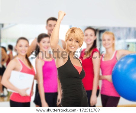 fitness, sport, training, gym and lifestyle concept - lovely fit woman with expression of triumph over white