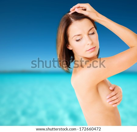 health, medicine and beauty concept - woman checking breast for signs of cancer