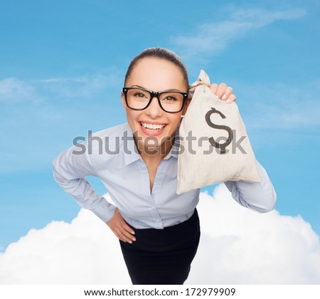 business, money and office concept - smiling businesswoman in eyeglasses holding money bag with dollar