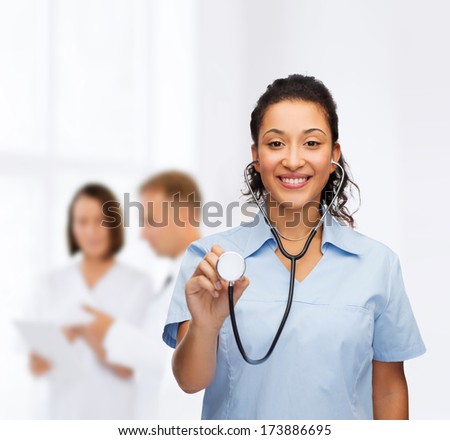 healthcare and medicine concept - smiling female african american doctor or nurse with stethoscope