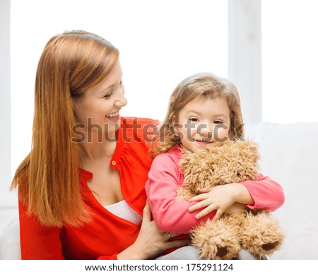 children, parenthood and happiness concept - happy mother and child with teddy bear at home