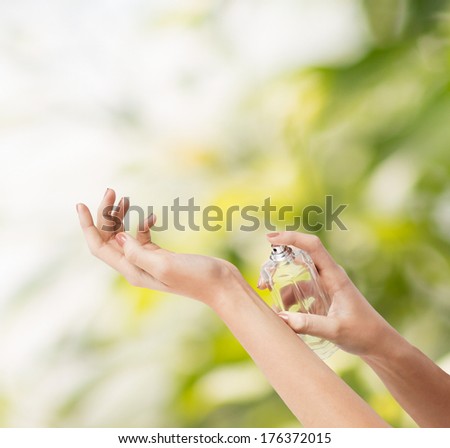 Cosmetics, Body Parts And Beauty Concept - Close Up Of Woman Hands Spraying Perfume