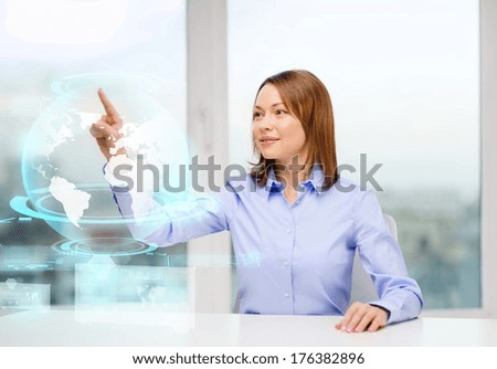 business, education and technology concept - smiling woman pointing to earth hologram