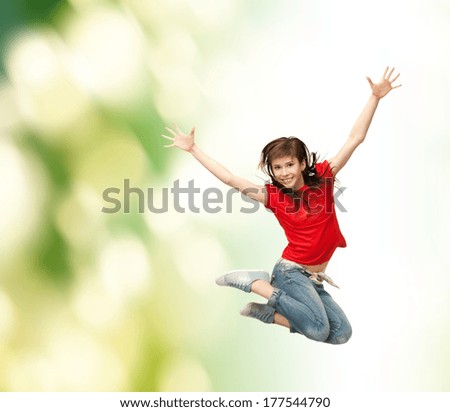 youth and fitness concept - happy girl jumping in the air