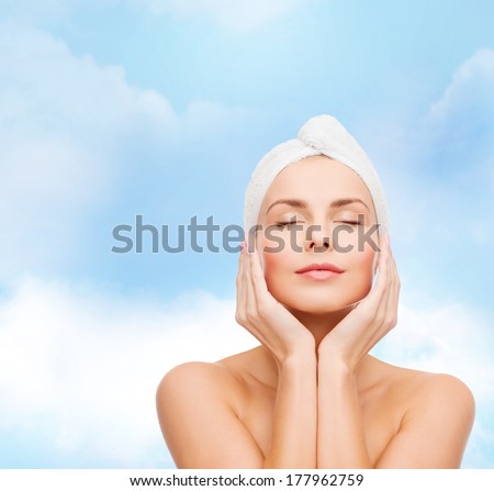 health, spa and beauty concept - beautiful woman in towel