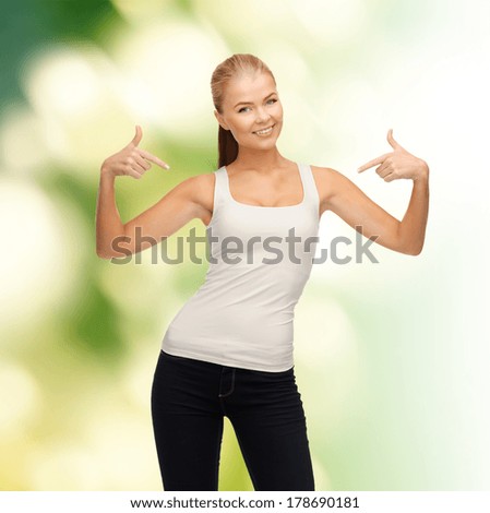 t-shirt design concept - happy woman in blank white t-shirt pointing at herself