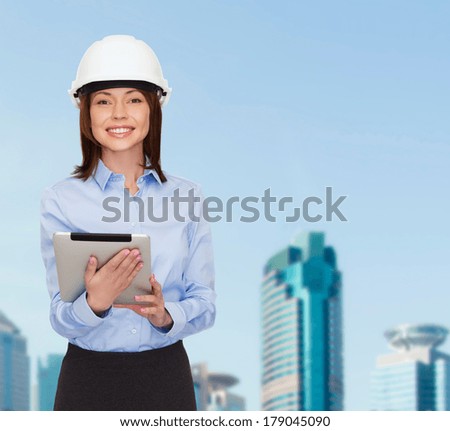 building, developing, consrtuction and architecture concept - friendly young smiling businesswoman in white helmet