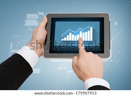 business, internet, economics and technology concept - close up of man hands touching tablet pc with increasing chart on screen