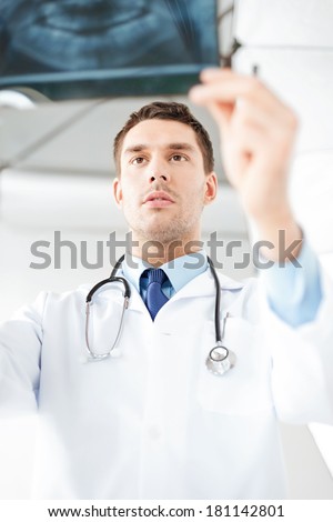 picture of male doctor or dentist looking at x-ray