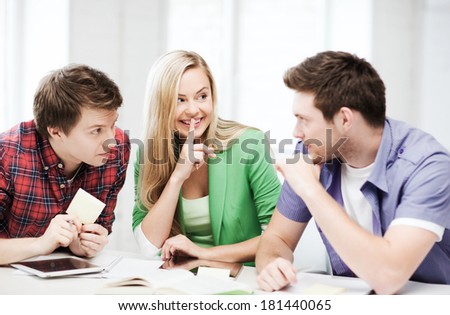 education concept - group of students gossiping at school
