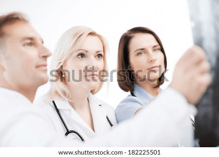 healthcare, medical and radiology concept - doctors looking at x-ray