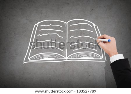 business and education concept - close up of businessman drawing book on concrete wall